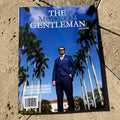 Magazine titled 'The Modern Gentleman' on a stone surface with palm trees in the background.