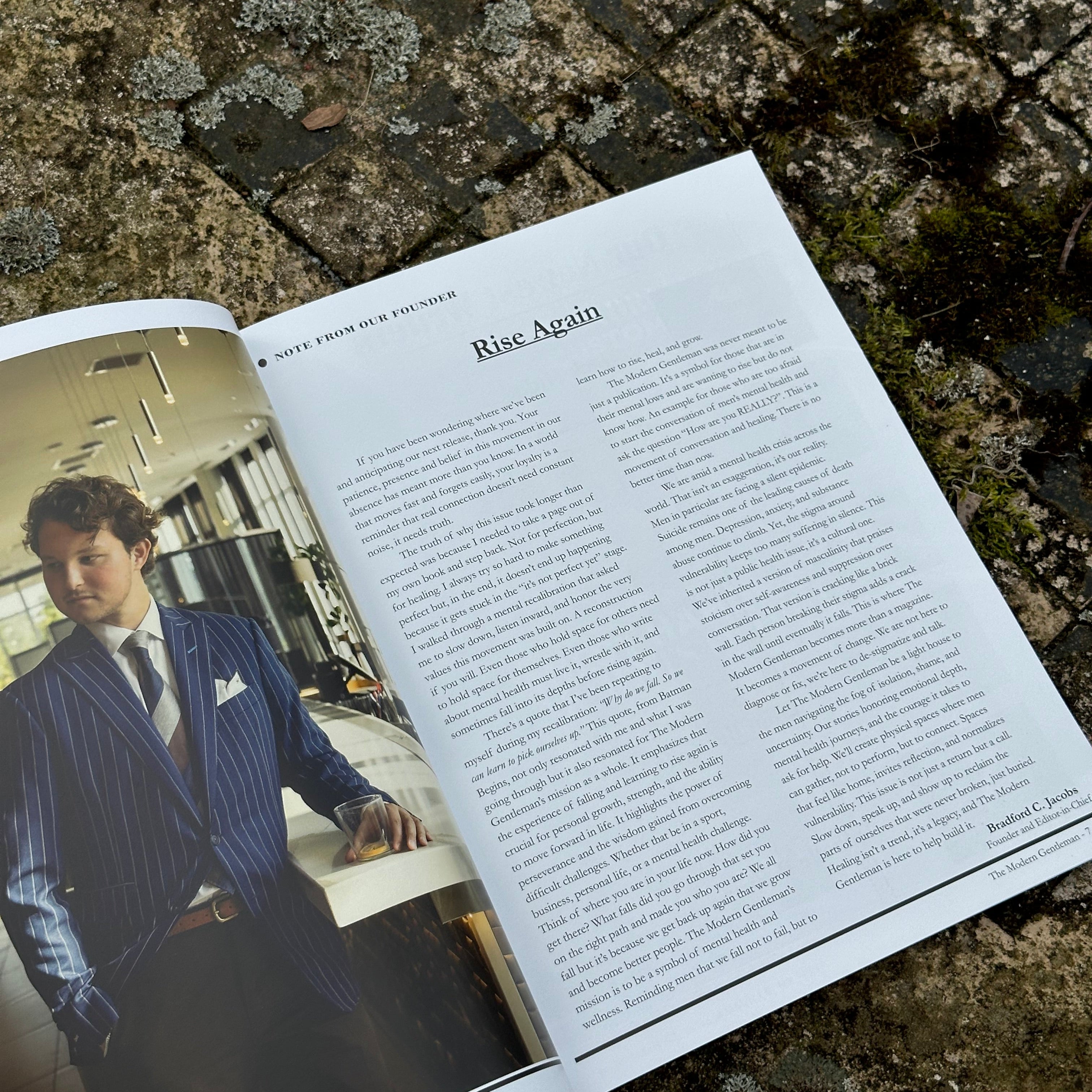 Open book with a photograph of a person on a textured stone surface